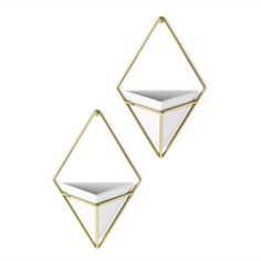 pair of white and gold geometric earrings on a white background with copy space in the middle