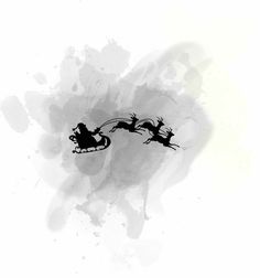 black and white photograph of santa sleigh flying through the sky with his reindeer