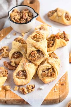 several pastries on a cutting board with walnuts