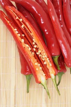 some red peppers are on a bamboo mat