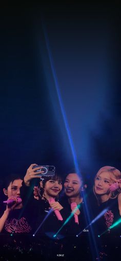 a group of people standing on top of a stage with microphones in their hands