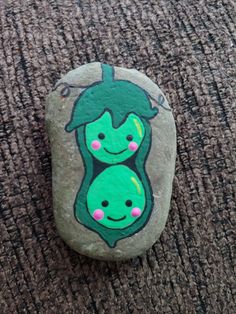 a rock with two peas painted on it