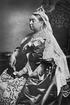 an old black and white photo of a woman wearing a tiara