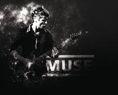 a man playing an electric guitar with the word music on it's back ground