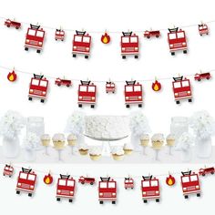 a table topped with cupcakes and cakes covered in firetruck paper decorations