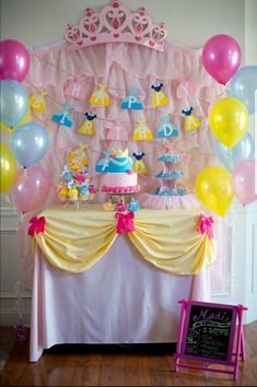 a birthday party with balloons, cake and decorations