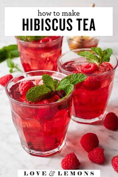 two glasses filled with raspberry hibiscus tea and mint garnish