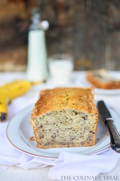 a loaf of banana bread sitting on top of a white plate