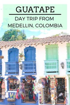 an old building with blue shutters and the words guatae day trip from medelli