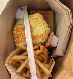 a box filled with french fries next to a bag of mcdonald's cheeseburger