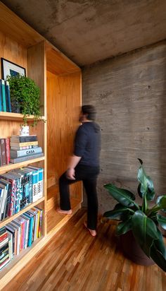 a person standing in front of a book shelf filled with books