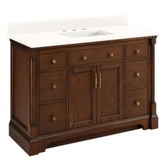 a bathroom vanity with white counter top and wooden cabinetry on the bottom, against a white background