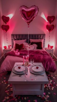 a bedroom with heart shaped balloons on the headboard and table set for valentine's day