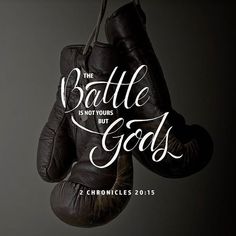 two black boxing gloves hanging from a rope with the words battle is not yours, but for