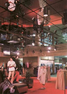 an image of a store with mannequins and clothes hanging from the ceiling