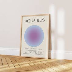 an aquarius poster is on the floor in front of a white wall and wooden floor