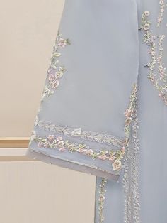 Pakistani Suits Chiffon - Embroidered Chiffon Shirt with Dupatta and Pant Introducing our elegant embroidered chiffon shirt with dupatta and pant, a perfect choice for those who appreciate intricate detailing and graceful style. Crafted from high-quality chiffon fabric, this shirt offers a lightweight and luxurious feel, allowing you to feel comfortable and chic throughout the day. The set comes with matching pants, which enhances the overall look and adds a touch of finesse to your outfit. Leng Blue Chiffon Sets With Sheer Dupatta, Embroidered Chiffon Sets With Long Sleeves, Light Blue Georgette Dress With Resham Embroidery, Blue Chiffon Set With Dupatta, Formal Georgette Fabric With Intricate Embroidery, Formal Georgette Fabric With Chikankari Embroidery, Formal Chikankari Embroidered Georgette Fabric, Elegant Blue Chikankari Embroidered Fabric, Formal Embroidered Chiffon Sets