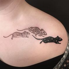 a woman's chest with two rat and mouse tattoos on the left side of her breast