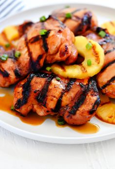 grilled chicken and pineapples on a white plate