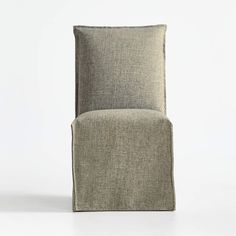 an upholstered chair on a white background with no one in the room around it