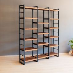 three shelving units with wooden shelves in the middle