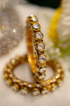 22k gold plated bangles with clear polki stone studded round patterns. - Aza Fashions