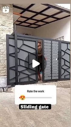 a man standing in front of a metal door with the words sliding gate on it