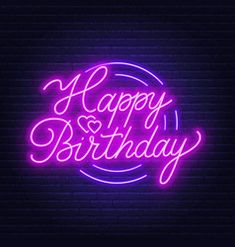 happy birthday neon sign on dark brick wall with blue and pink lights in the background