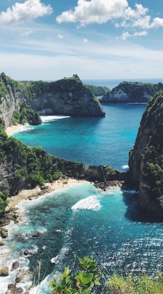 the ocean is surrounded by rocky cliffs and blue water