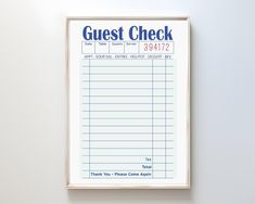 a sign hanging on the wall that says guest check in blue and white writing below it