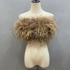 a white mannequin with some brown fur on it