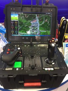 an open laptop computer sitting on top of a table next to a game controller and controllers