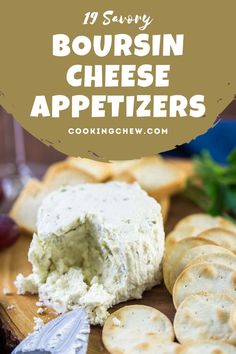 cheese appetizers on a cutting board with crackers and grapes in the background