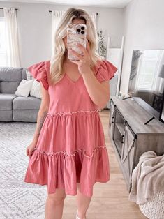 Our Remembrance Babydoll Dress features a matte pink cotton material, v-neckline, ruffled shorts sleeves, self tie bow detail in upper back, tiered skirt, side pockets. Model is 5'1", 34D, 6/28 and is wearing a size medium. Item runs true to size with a babydoll style fit. More details: 100% cotton. hand wash or wash on cold and hang to dry Tiered Babydoll Dress, Ruffled Shorts, Babydoll Style, Matte Pink, Tie Bow, Ruffle Shorts, Tier Skirt, Tiered Skirt, Babydoll Dress