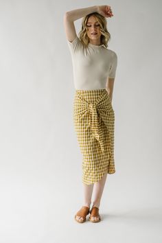 Liven up your wardrobe with The Yancy Gingham Skirt! A playful knot tie creates a fun and unique look with classic gingham pattern. Flaunt your style and show off your mustard and white duo with this must-have skirt! size up Details Model is wearing a small self/lining: 55% rayon + 43% polyester + 2% spandex Fabric Care Guide Here Sizing & Fit Measurements are approximate and taken while laying flat across the front. Not doubled. small: waist = 13"; length = 34" medium: waist = 13.5"; length = 3 Piper And Scoot, Color Block Maxi Dress, Patterned Skirt, Gingham Skirt, Knot Tie, Henley Tee, Gingham Pattern, Tiered Midi Dress, Print Bodysuit