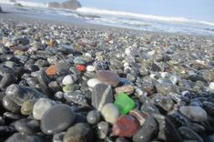 many different colored rocks and pebbles on the beach