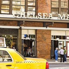 a taxi cab is parked in front of the chelsea market