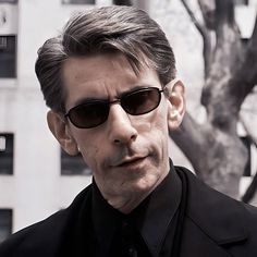 a man wearing sunglasses and a black shirt