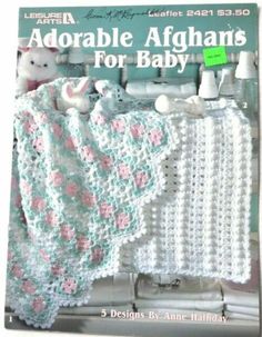 the front cover of a crocheted baby afghans pattern book, featuring two white teddy bears