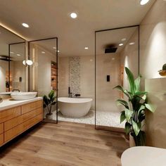 a large bathroom with two sinks and a bathtub in the middle of the room