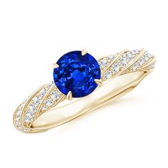 an oval blue sapphire and diamond ring in yellow gold