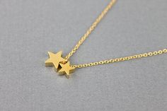 So cute and tiny two gold star charm necklace is great to wear for everyday or special occasionsAvailable in gold and silver MATERIALSGold plated rhodiumSIZECharm : 3/8 '' ( L ) 1/4 '' ( S )Chain length : 15 '' to 17 '' adjustable ( 2 inches extender )SHIPPING TIMEFast shipping within 1 - 3 days******Your order will be ready to be shipped within in 3 business days in USA If you have any question please feel free to contact me******Comes in a individual gift box , Ready for your presentation ♥ Se Minimalist Gold Necklace With Star Charm, Gold Necklaces With Star Charm For Birthday, Gold Star Necklaces For Birthday Gift, Dainty Gold Plated Star Charm Necklace, Gold Star Necklace For Birthday Gift, Star-shaped Tiny Necklace For Gift, Dainty Star-shaped Necklace For Gift, 14k Gold-filled Star Charm Necklace As Gift, Circle Charm Necklace