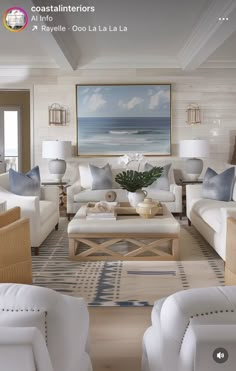 a living room filled with white furniture and lots of pillows on top of it's couches