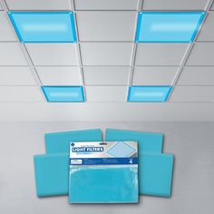 the light filters are blue and white in this office space, with square lights on the ceiling