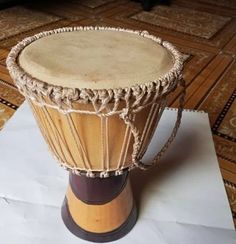 a wooden drum sitting on top of a piece of paper