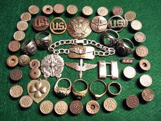 an assortment of various metal items on a green surface