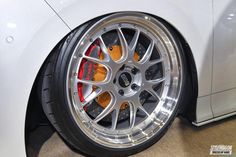 the front wheel of a white sports car