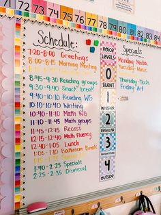 a whiteboard with numbers and times on it in a classroom setting that is decorated with pastel colors