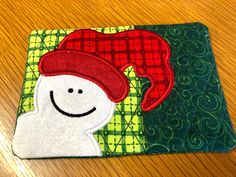 a close up of a piece of cloth on a wooden table with a smiling face