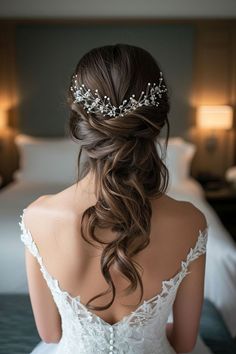 a woman in a wedding dress with a tiara on her head is looking at the bed